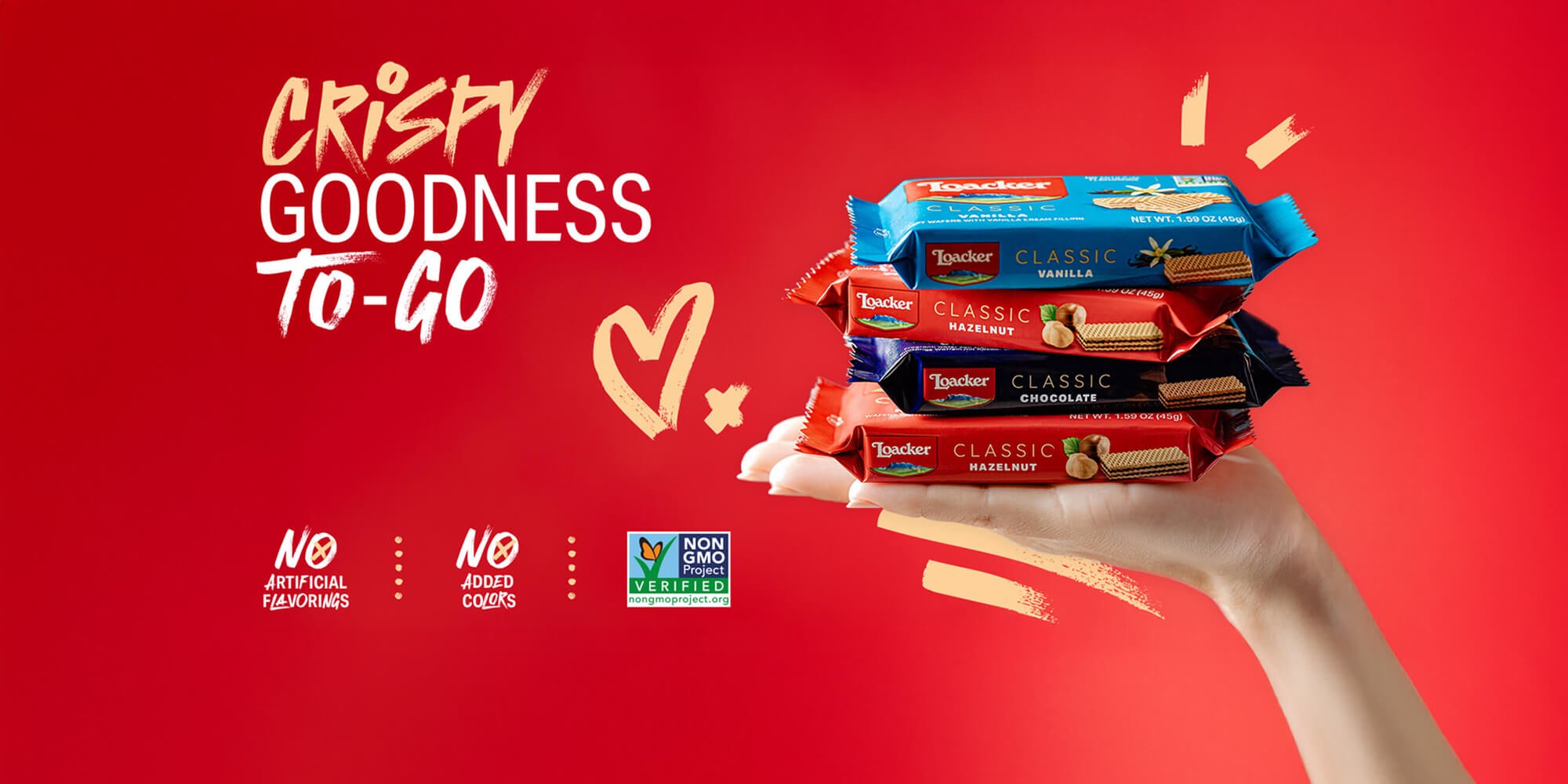 Hand holding Loacker wafers with 'Crispy Goodness To-Go' text on a red background