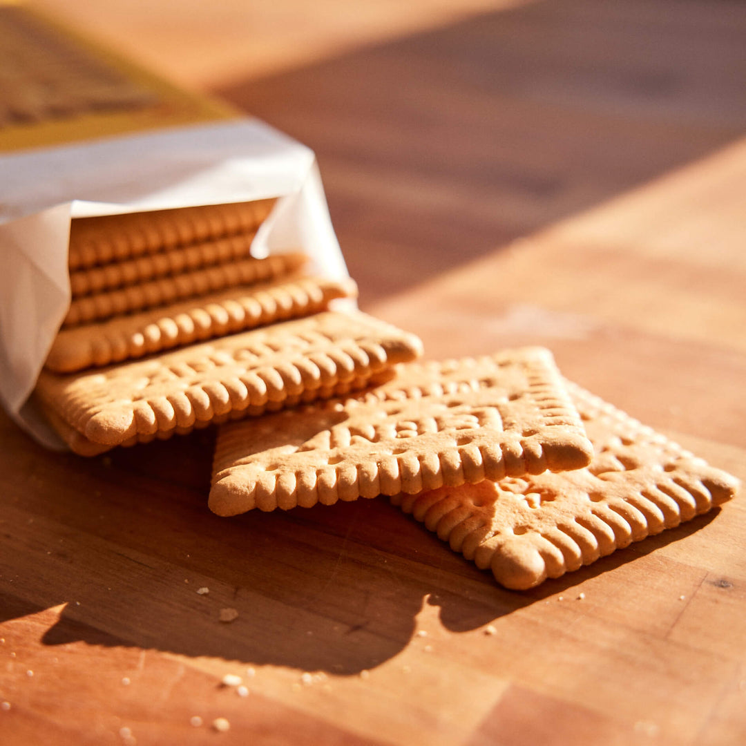 Biscuits on a wooden surface with a partially visible packaging.