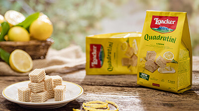 Loacker Quadratini and unwrapped wafers on a plate with lemons as the background