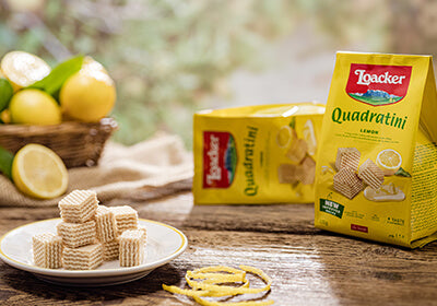 Loacker Quadratini and unwrapped wafers on a plate with lemons as the background