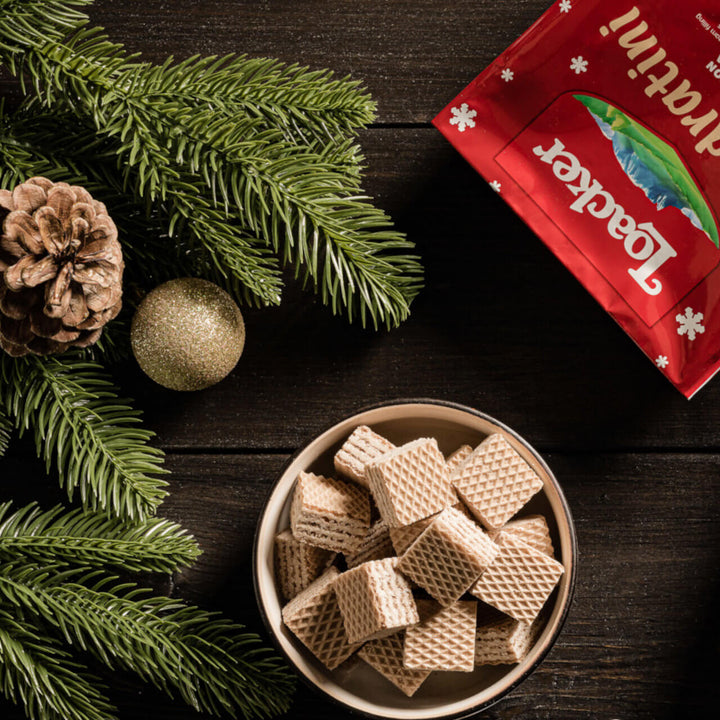 Quadratini Cinnamon, Creme-Filled Wafer Cookies, 8.82 oz. Bag and unwrapped in a bowl with plants and acorn next to it.