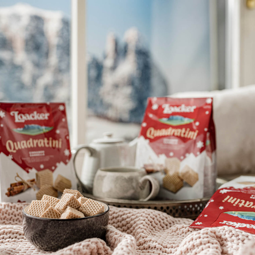 Quadratini Cinnamon, Creme-Filled Wafer Cookies, 8.82 oz. Bag and unwrapped in a bowl with winter background.