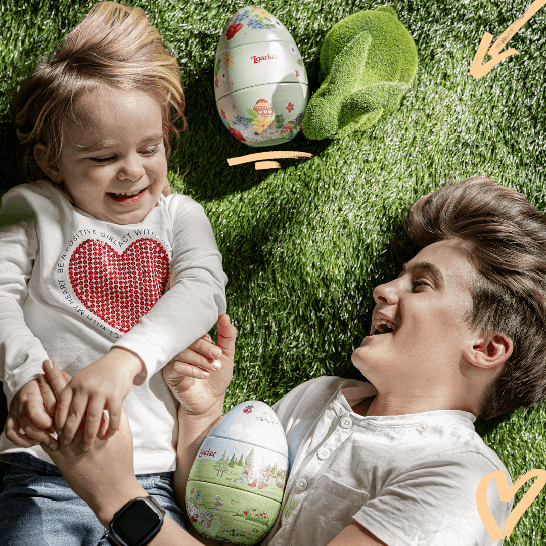 Loacker Easter Egg, Premium Wafer & Chocolate Specialties, 4.95 oz. Collector's Tin - Man and kid laughing on the field with Loacker Easter Eggs