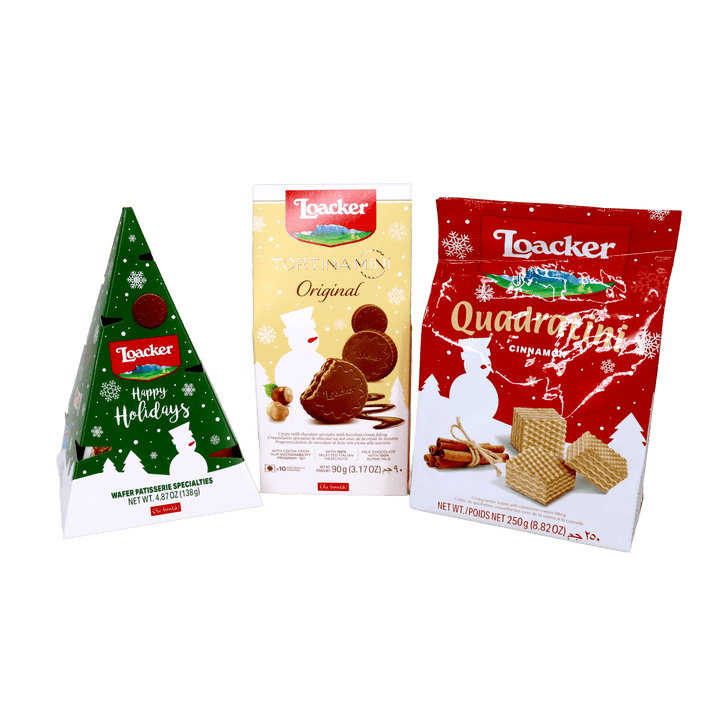 Loacker holiday wafer assortment featuring a Christmas tree-shaped gift package, Tortina Mini Original chocolate hazelnut wafers, and Quadratini Cinnamon wafer cubes.