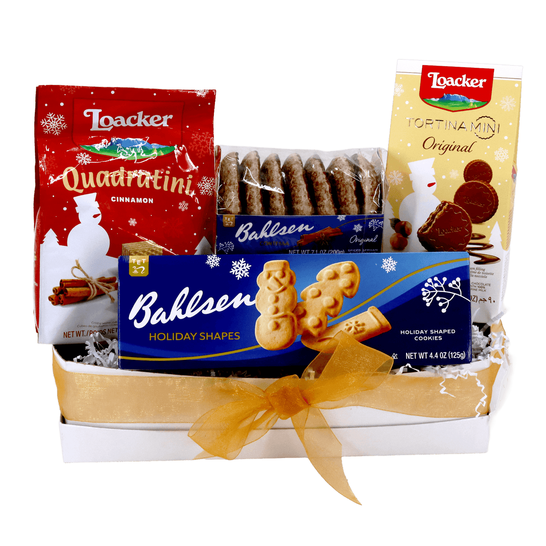 Loacker x Bahlsen Joy Gift Box featuring Quadratini Cinnamon wafers, Tortina Mini Original, Contessa Original gingerbread, and Holiday Shapes cookies in a white gift box with a gold ribbon.