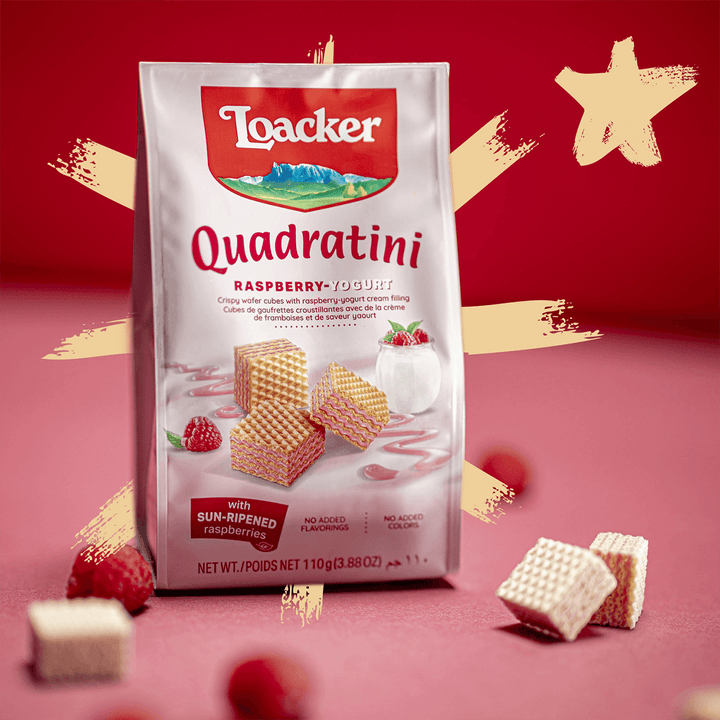Quadratini Spring Value Pack Raspberry yogurt with raspberries and unwrapped wafers next to it.